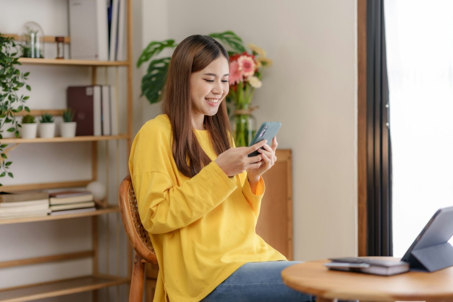 Beautiful young Asian woman using a smartphone transact on social media application